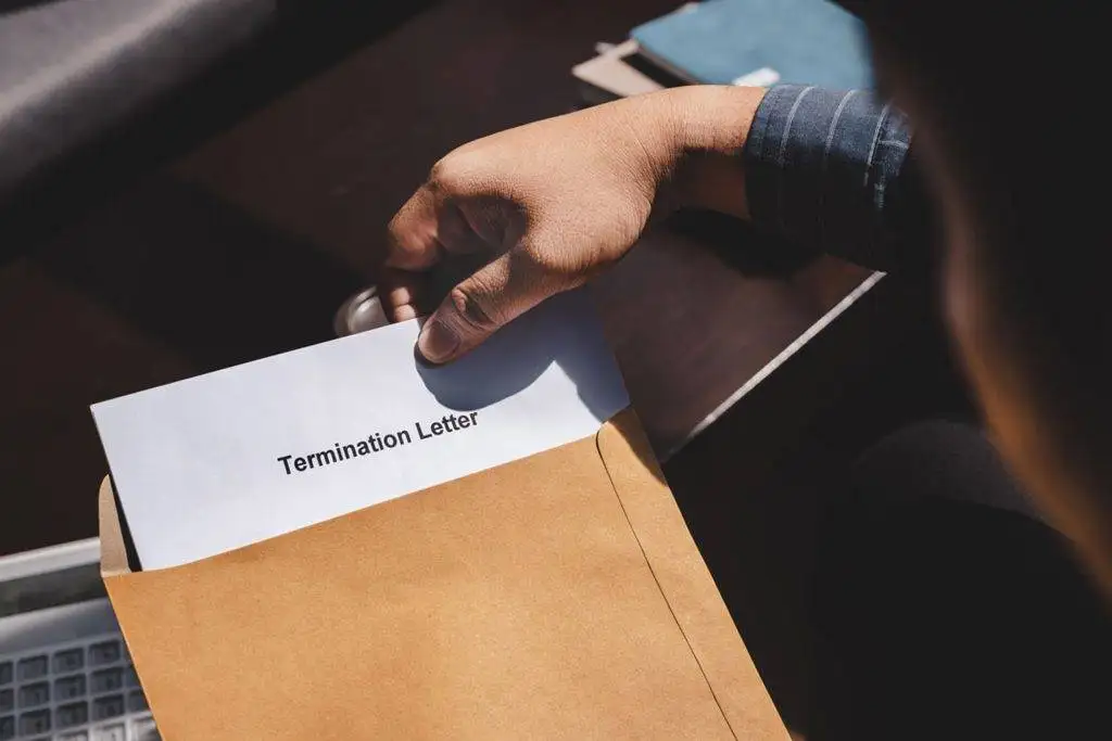 Termination letter sticking out of an envelope
