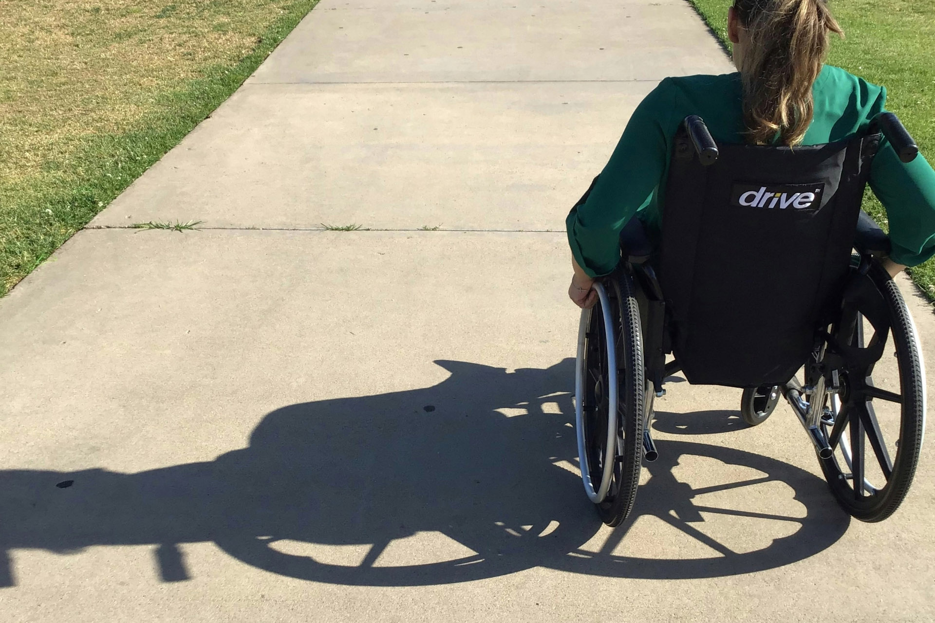 paralyzed woman in a wheelchair on a path