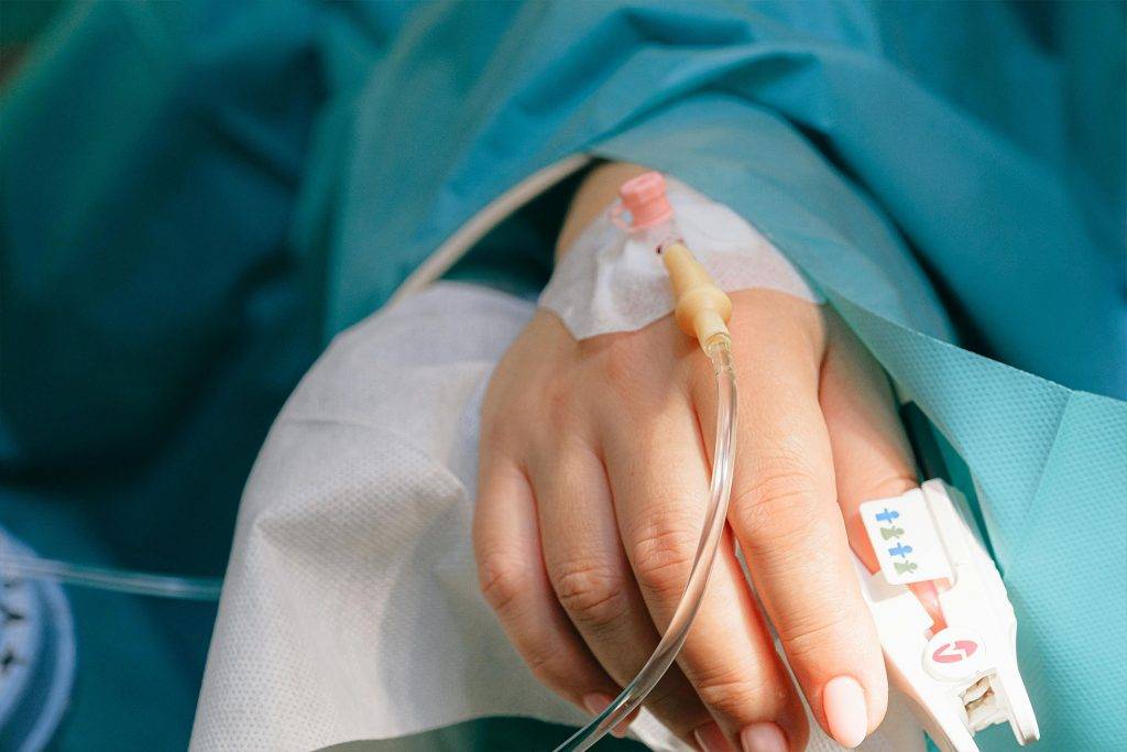 Close-up of a woman's hand on a drip after an accident in Hollywood