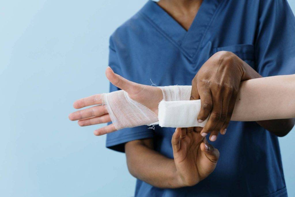 a nurse bandaging a patient's wrist after a personal injury accident in huntington beach