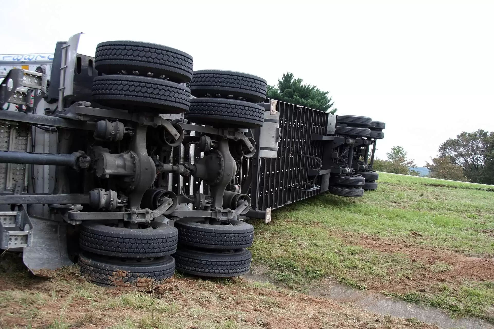 Overturned truck on the side of the road