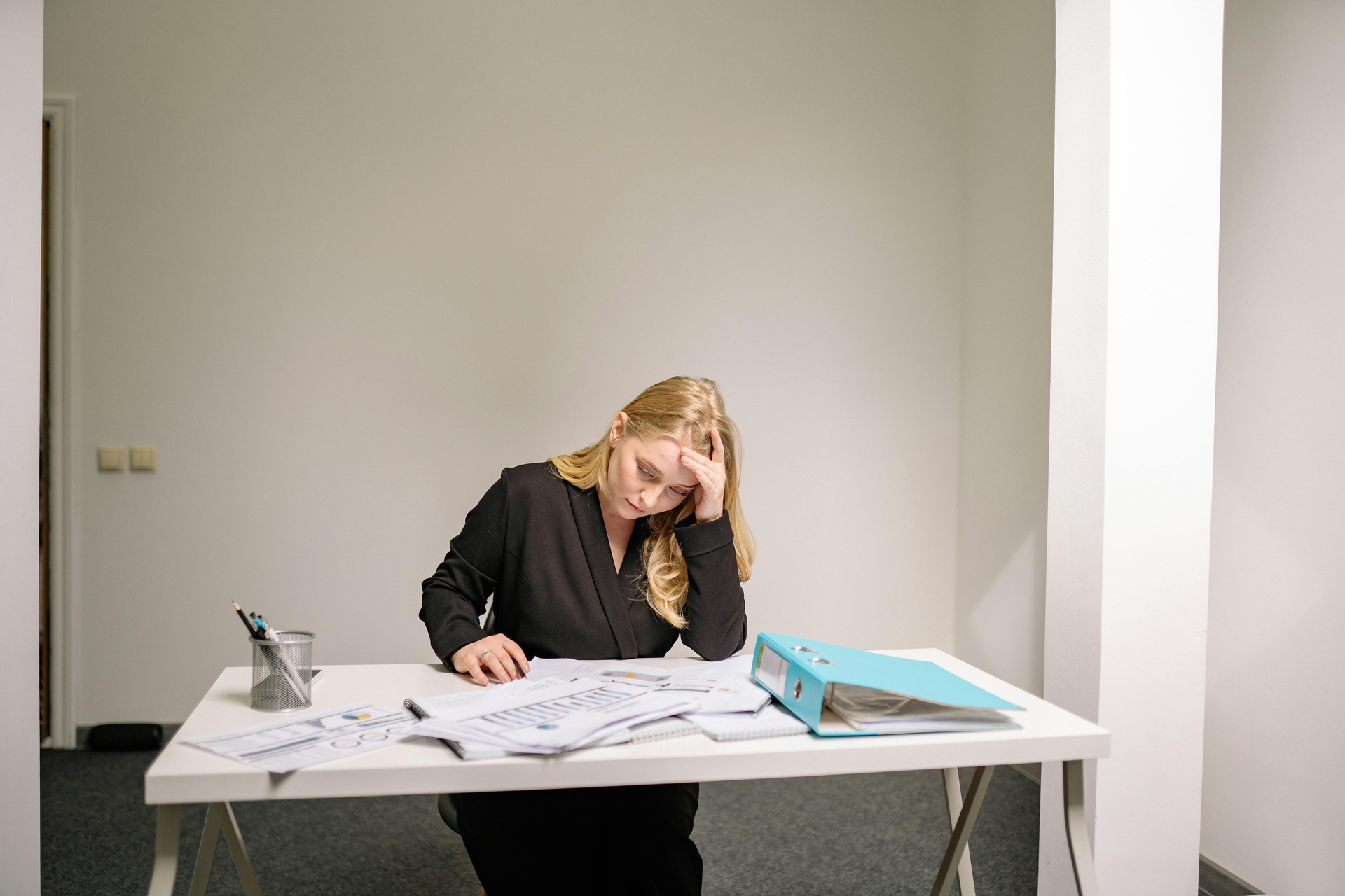 Businesswoman overwhelmed with paperwork at office desk