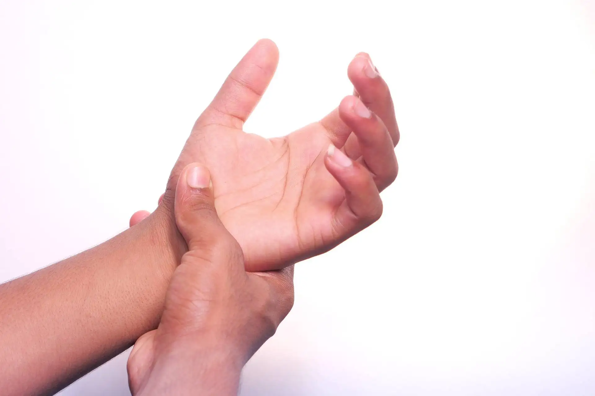 Man suffering pain in hand isolated in white .