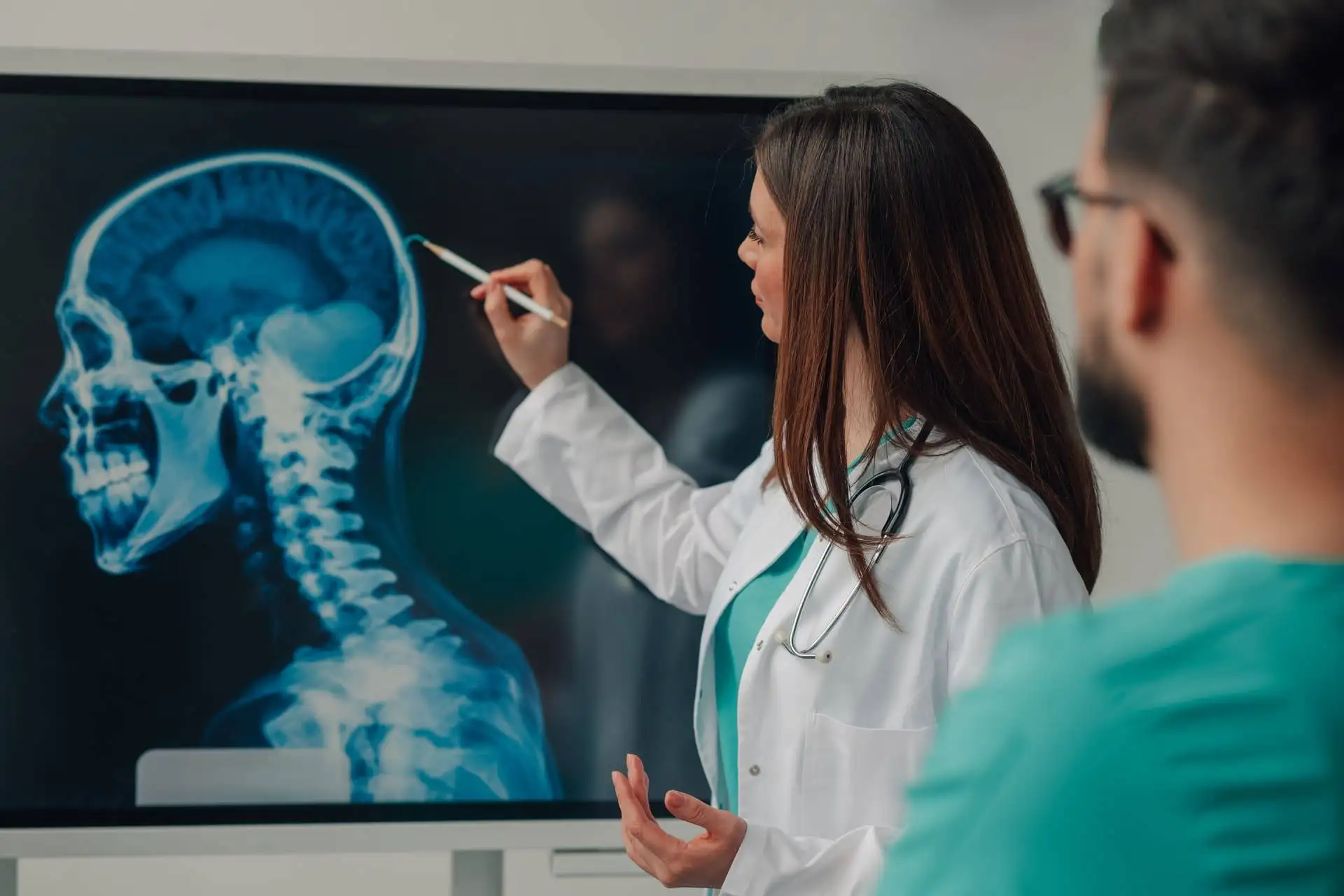 Doctor explaining head and neck X-ray results to a patient