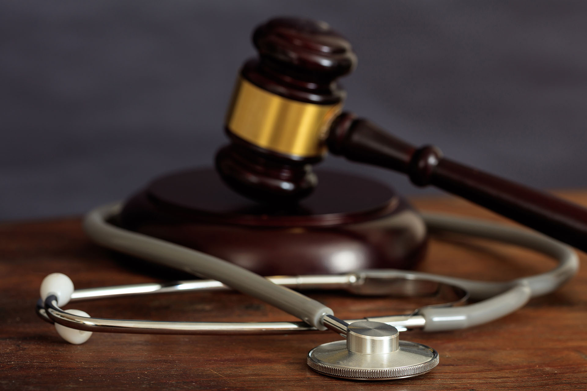 a gavel and block with a stethoscope wrapped around them