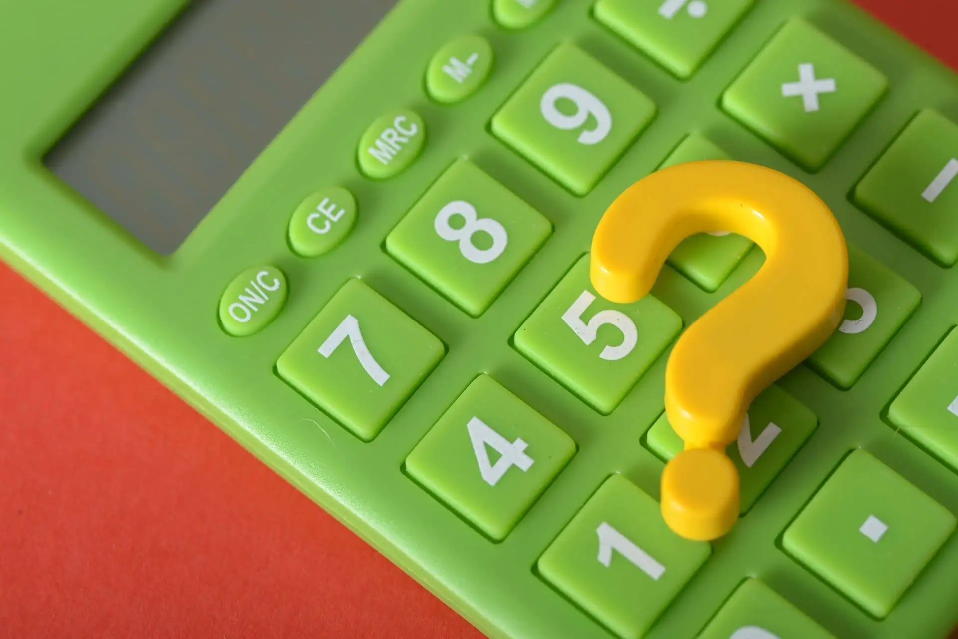 Green calculator with a yellow question mark on the keys