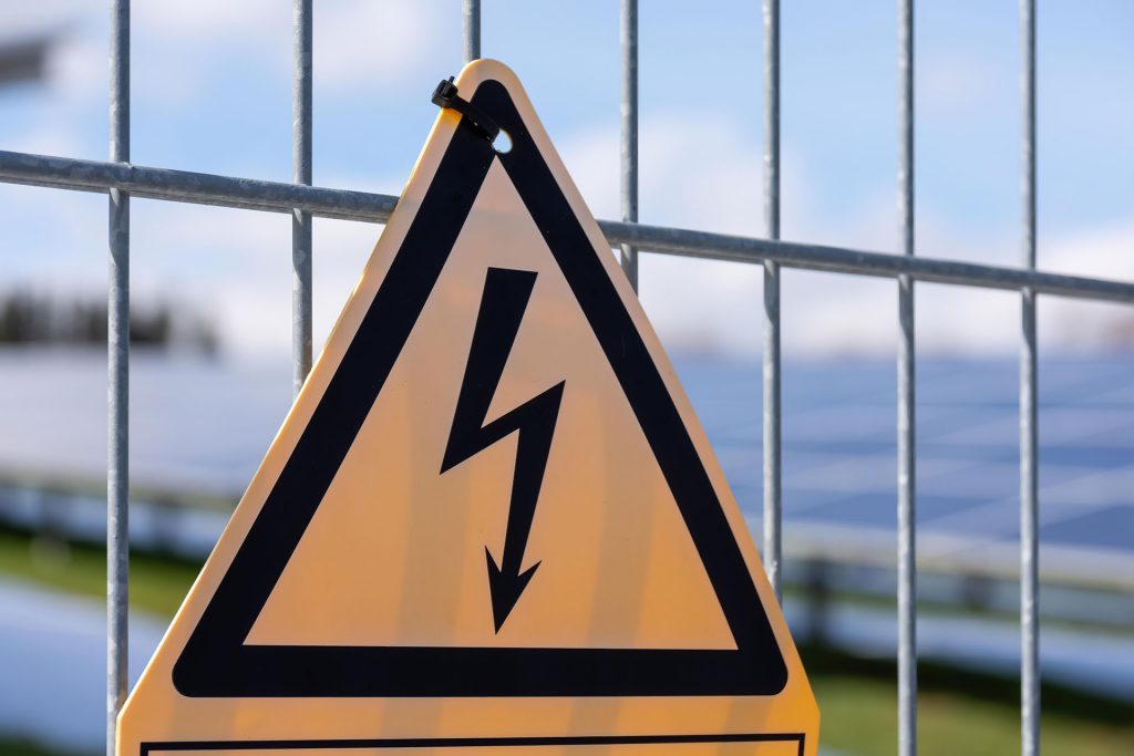 electrocution warning sign on a fence