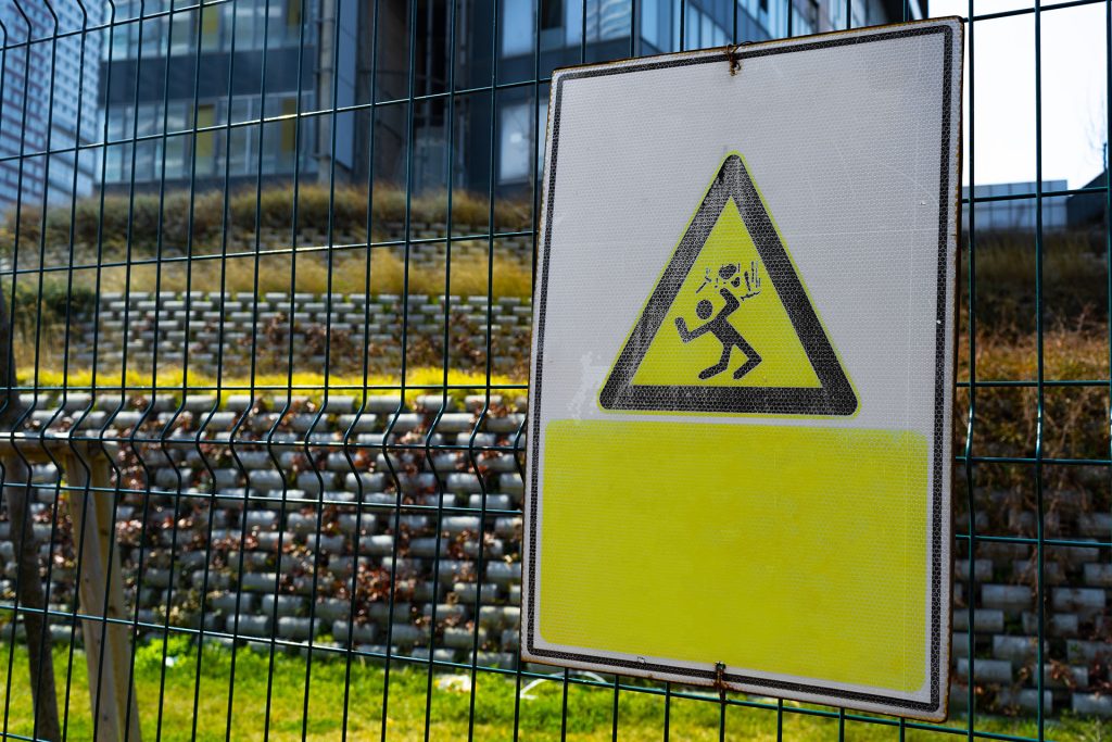 high voltage warning sign on a fence