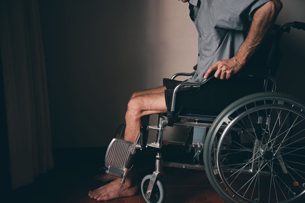 paralysed man from the waist down sat in a wheelchair