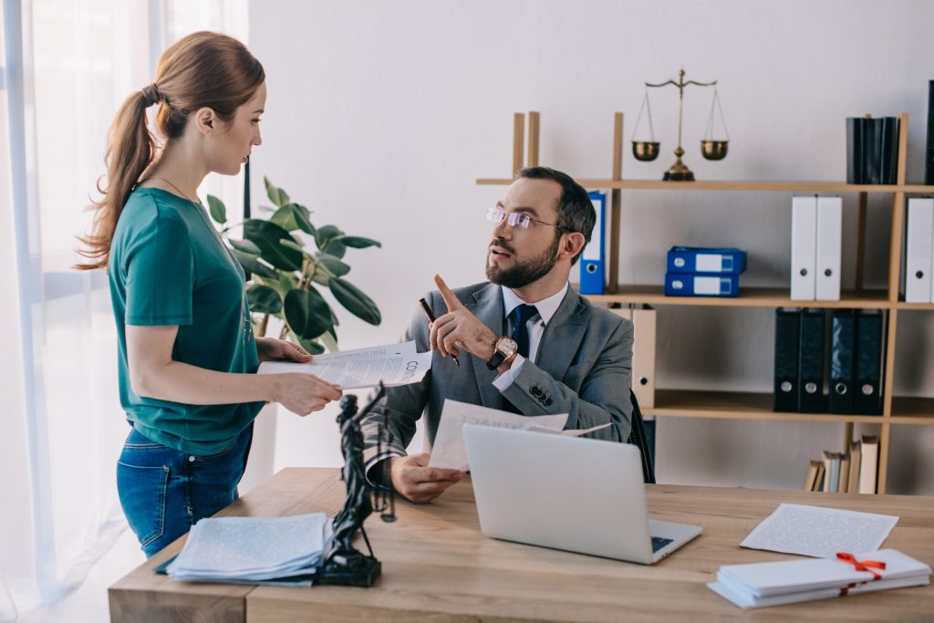 Lawyer and client discussing contract paper