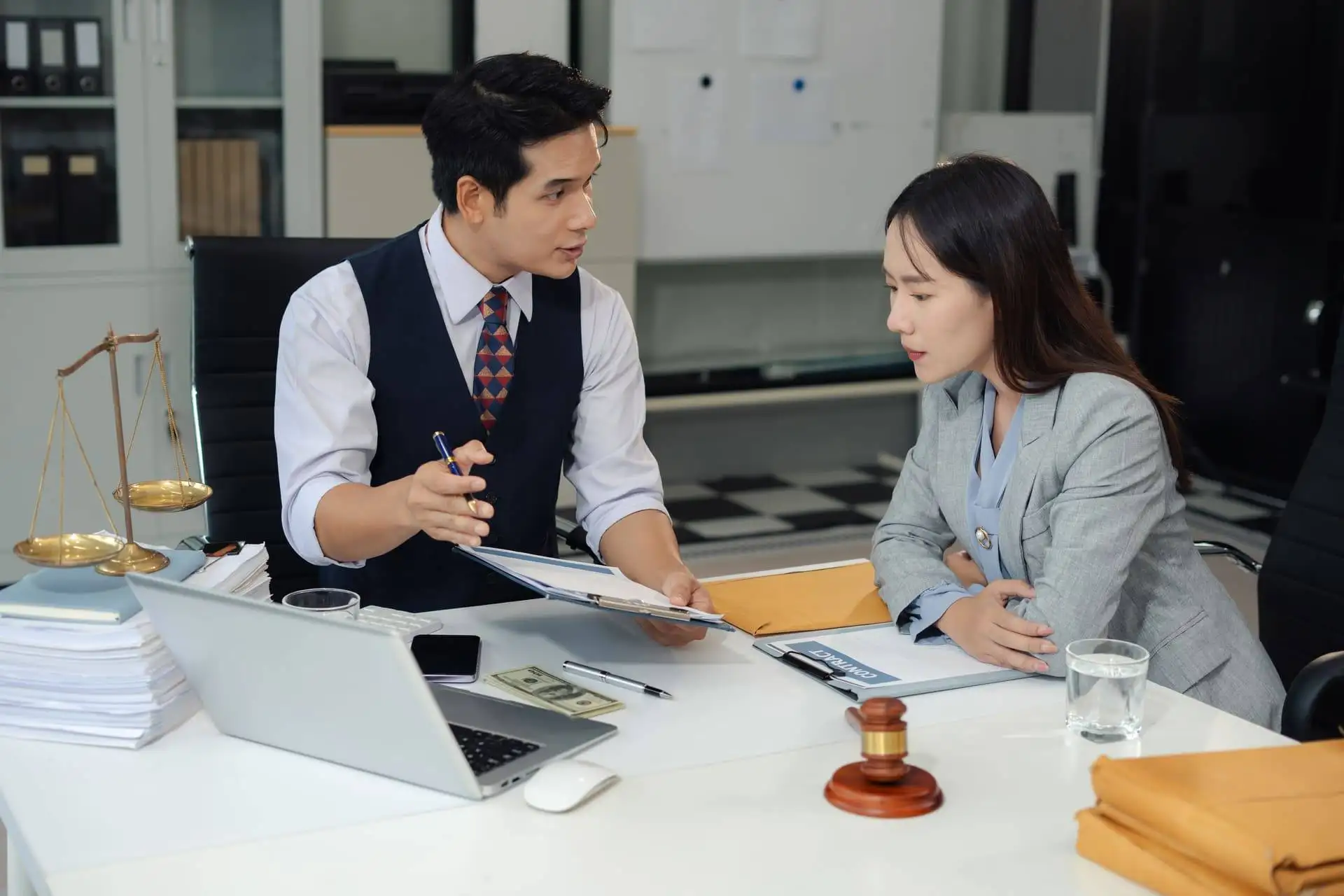 Lawyer explaining legal documents to a client in an office