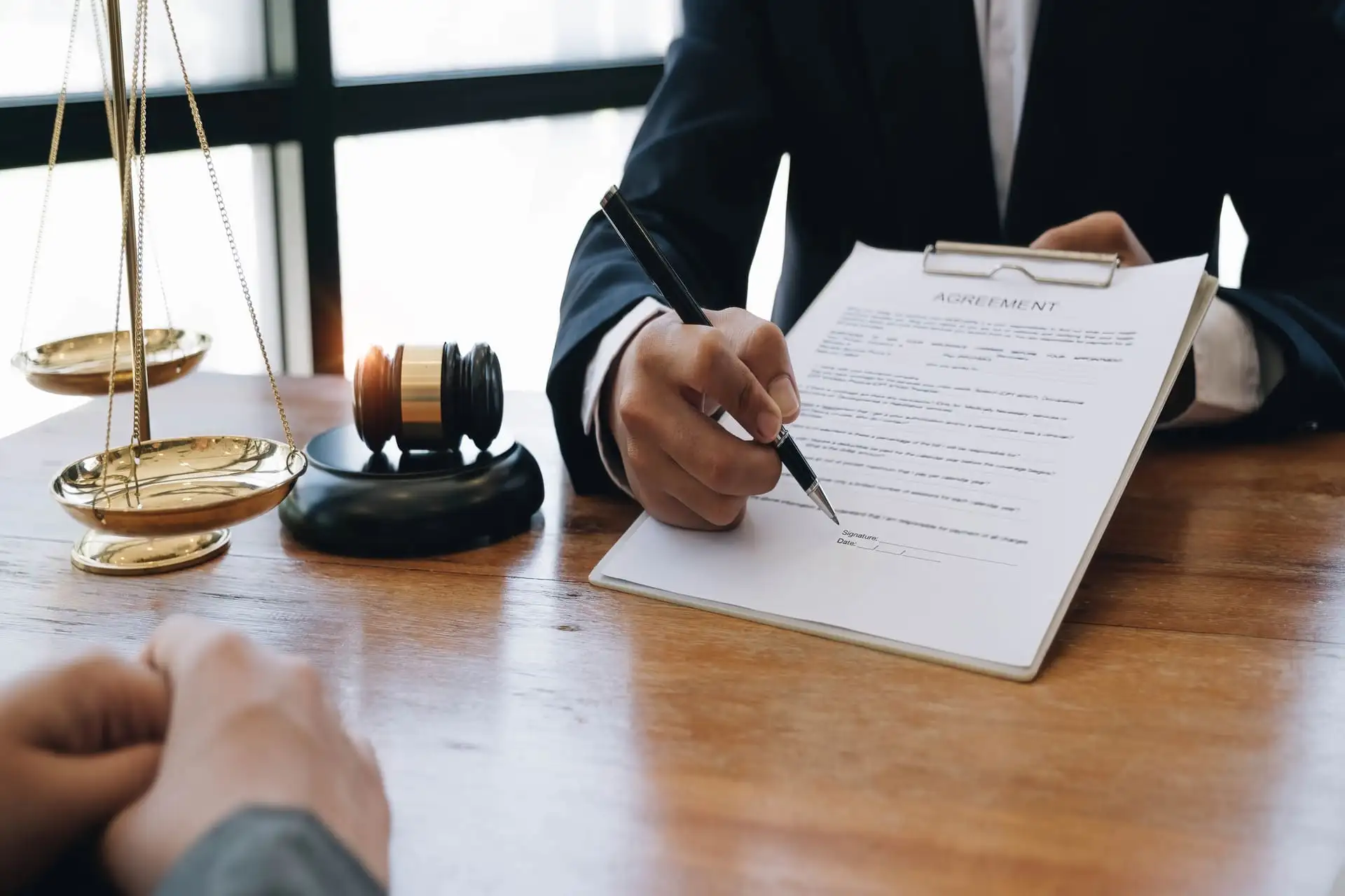 Lawyer reviewing and signing an agreement document