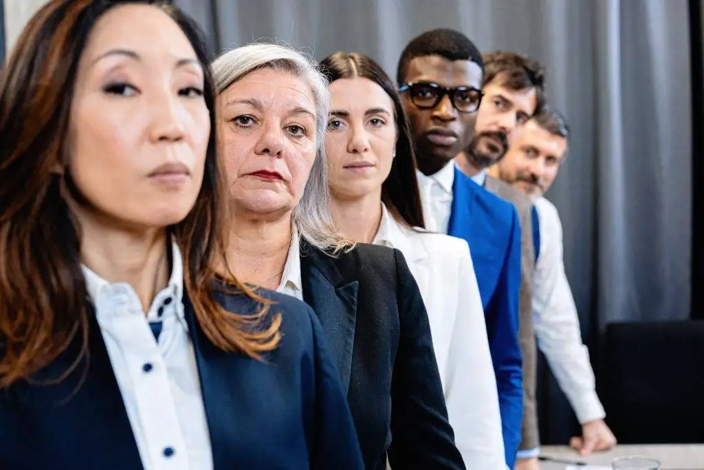 Multi-generational and diverse team lined up in professional attire