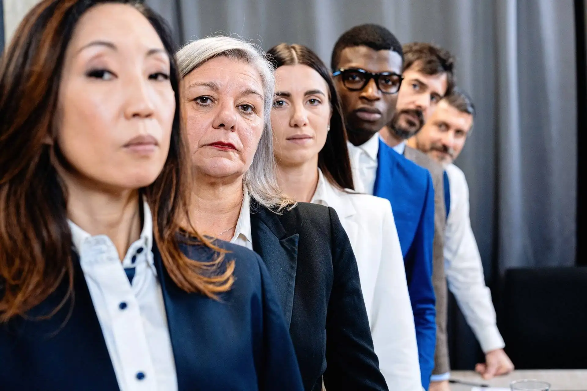 Multi-generational and diverse team lined up in professional attire