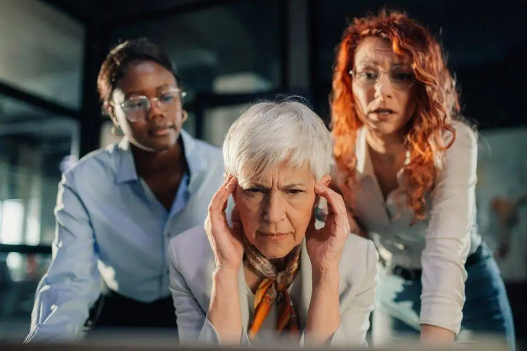 Team of businesswomen looking concerned while reviewing report on screen