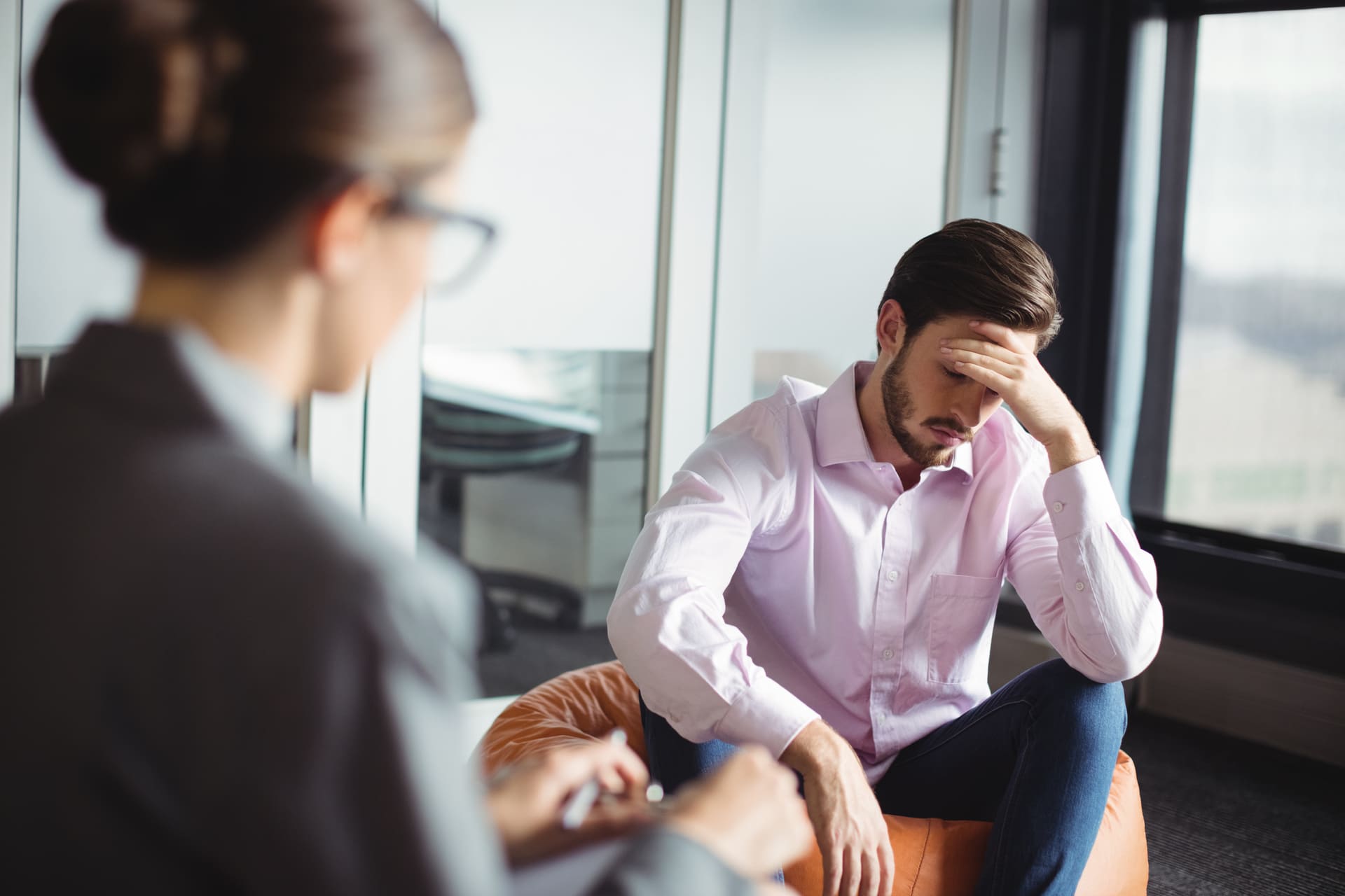 Upset man consulting a counselor during a private session