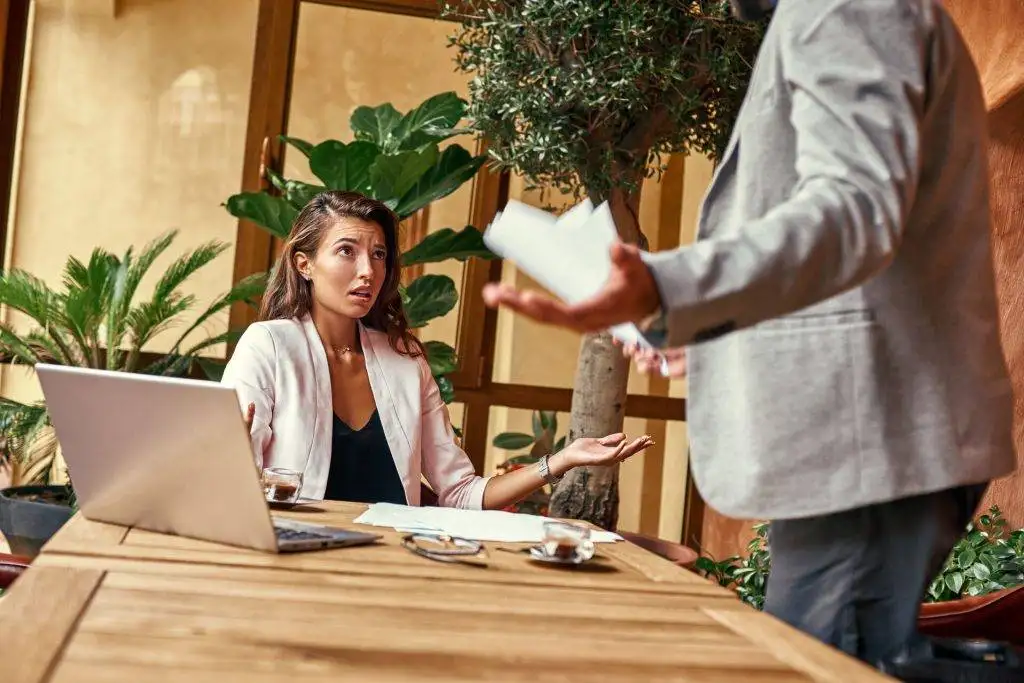 Woman reacting to argument during meeting