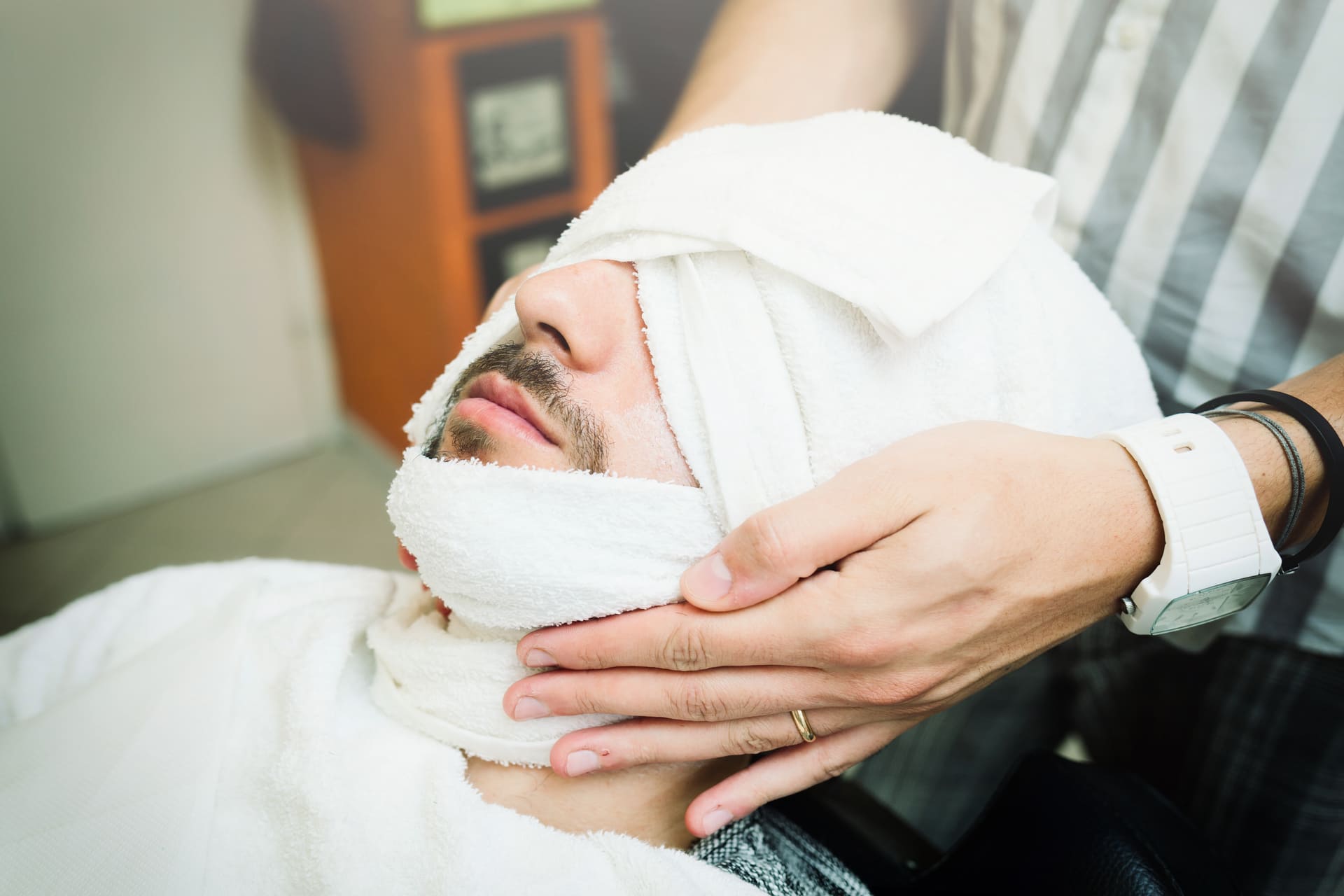 doctor holding patient head in bandages