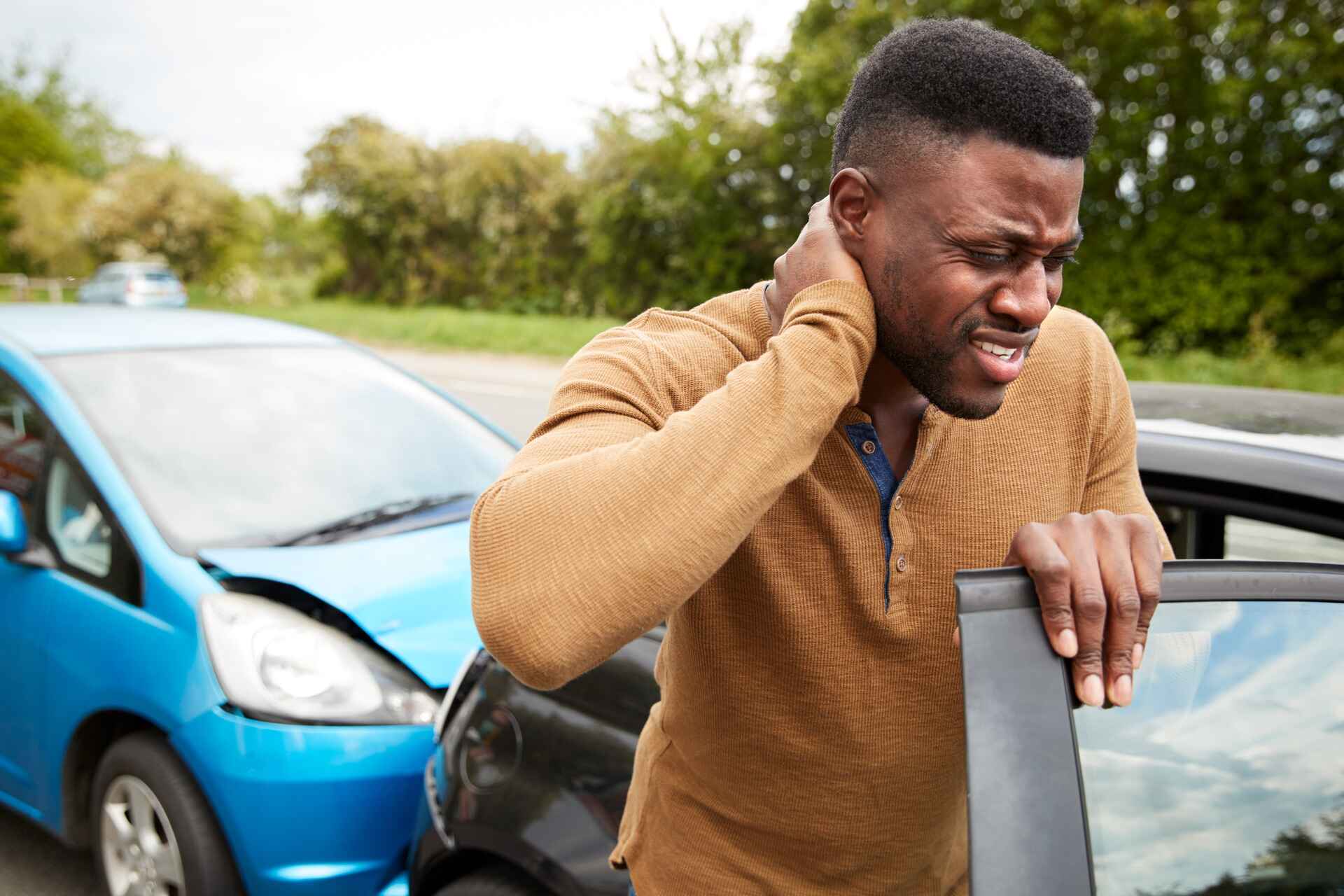 male driver with whiplash injury