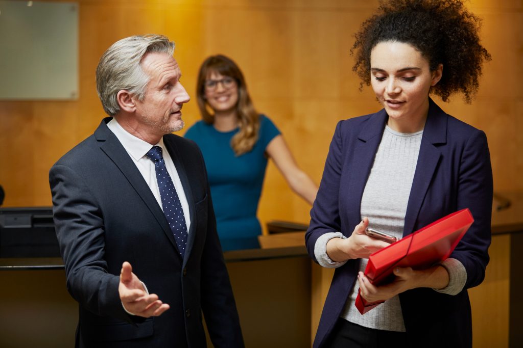 male lawyer discussing workplace retaliation with female client