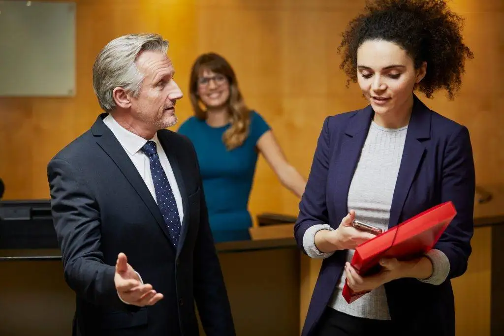 male lawyer discussing workplace retaliation with female client