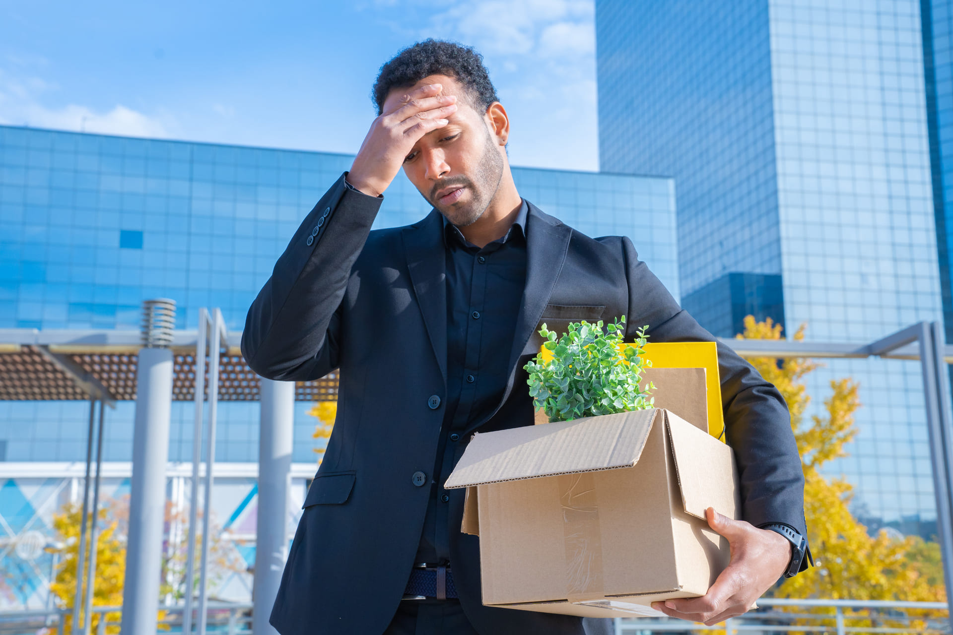 man fired with cardboard in hands