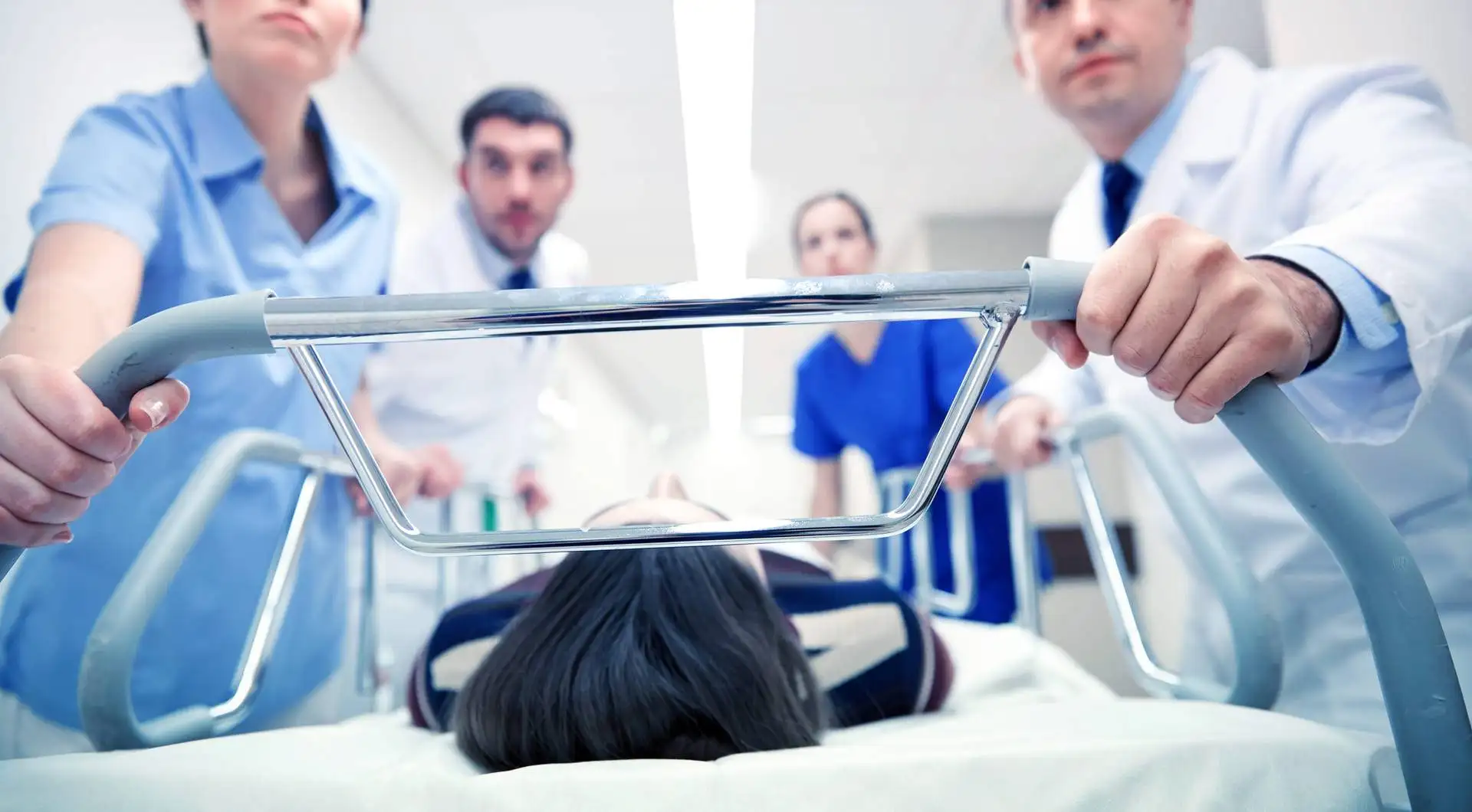 Medics above pation who is lying on bed
