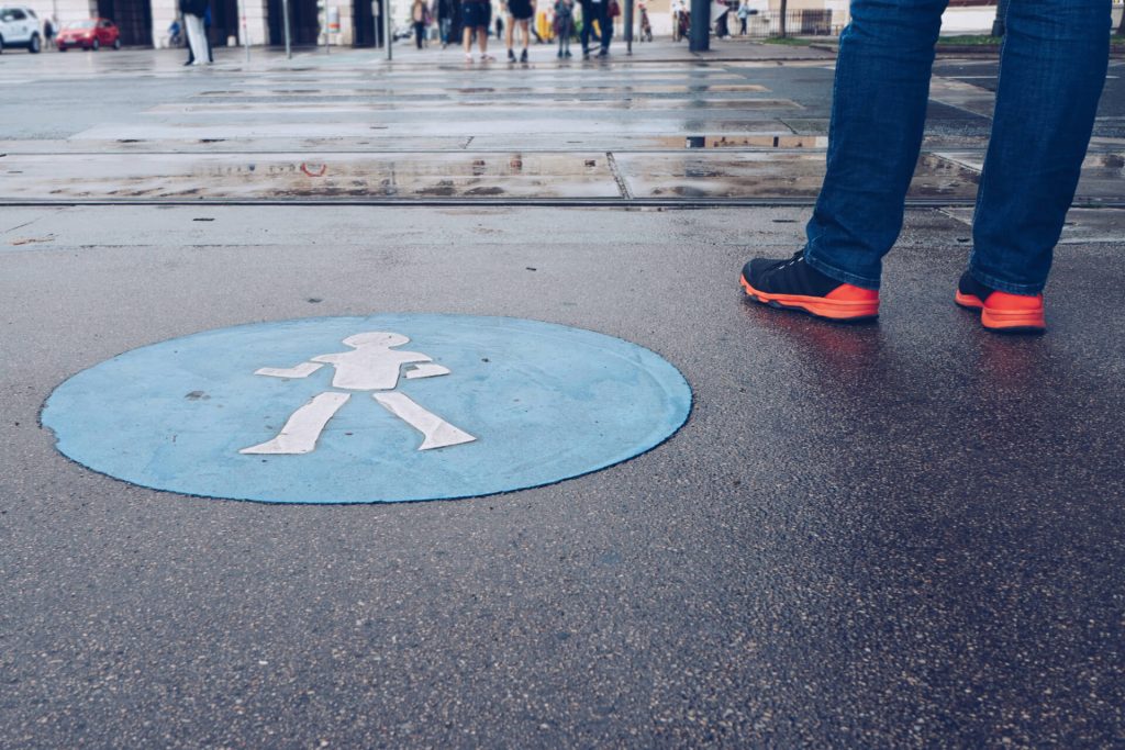 pedestrian stood next to a pedestrian crossing