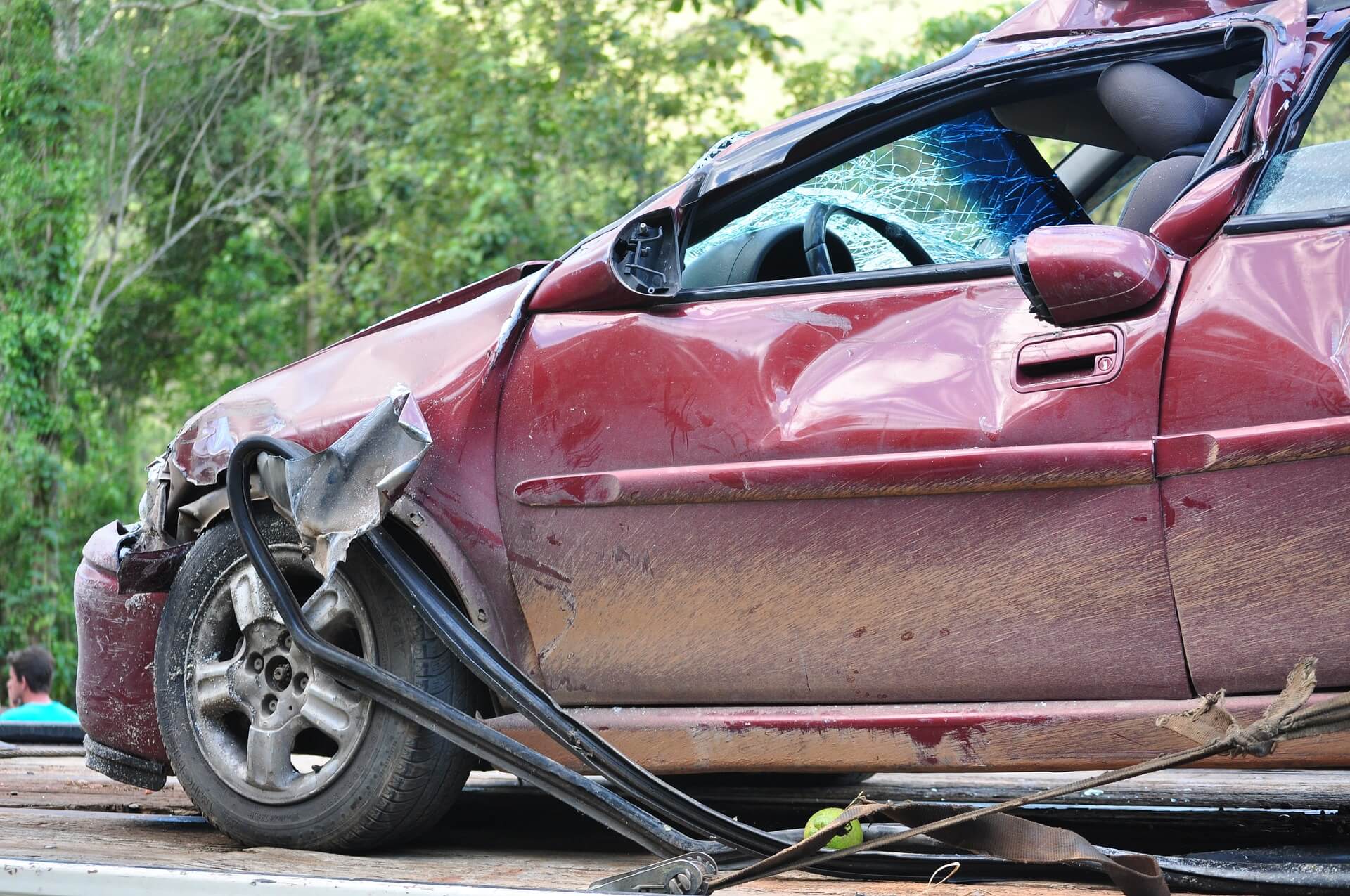 red car crumpled after a collision