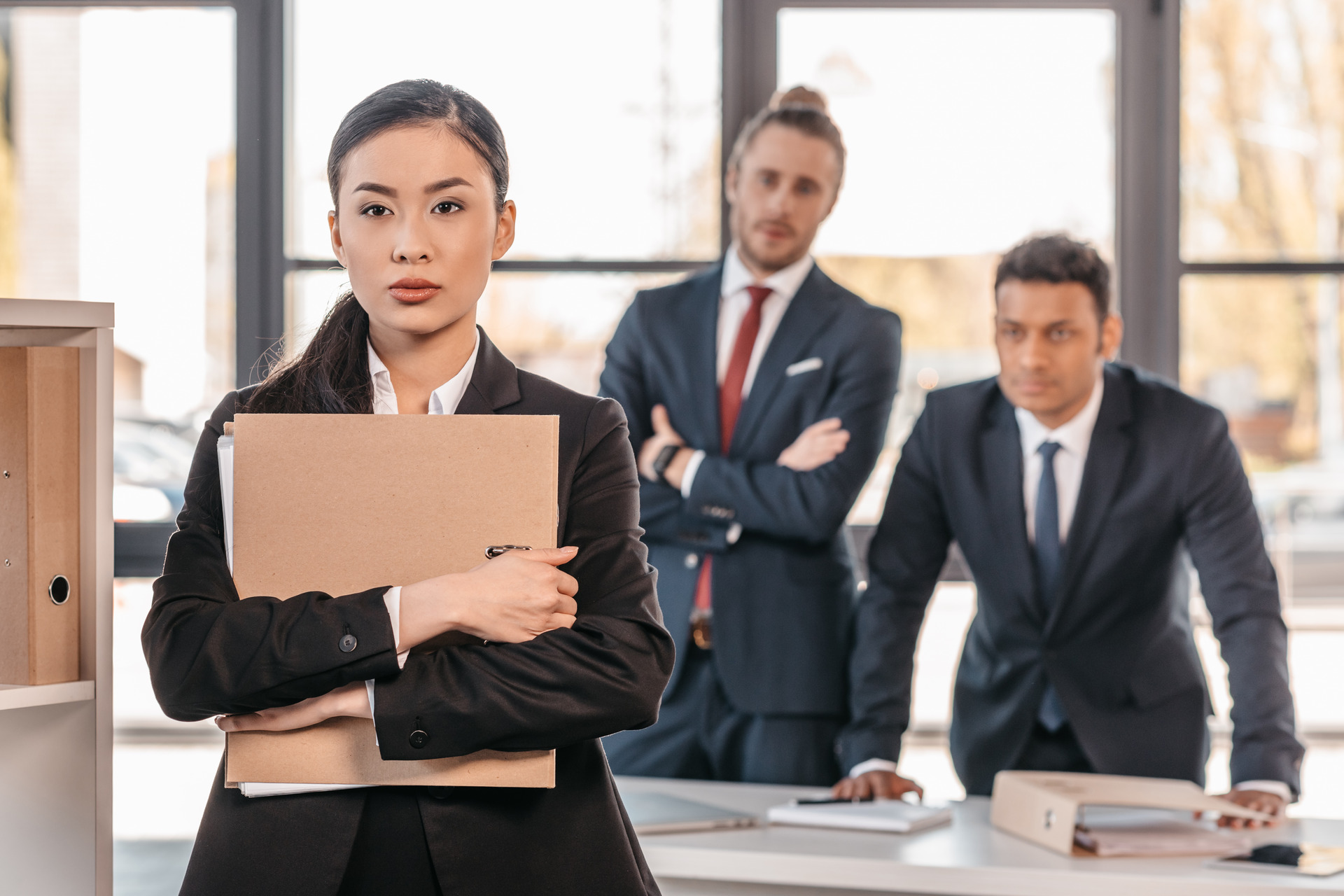 woman holding folder in front of employers