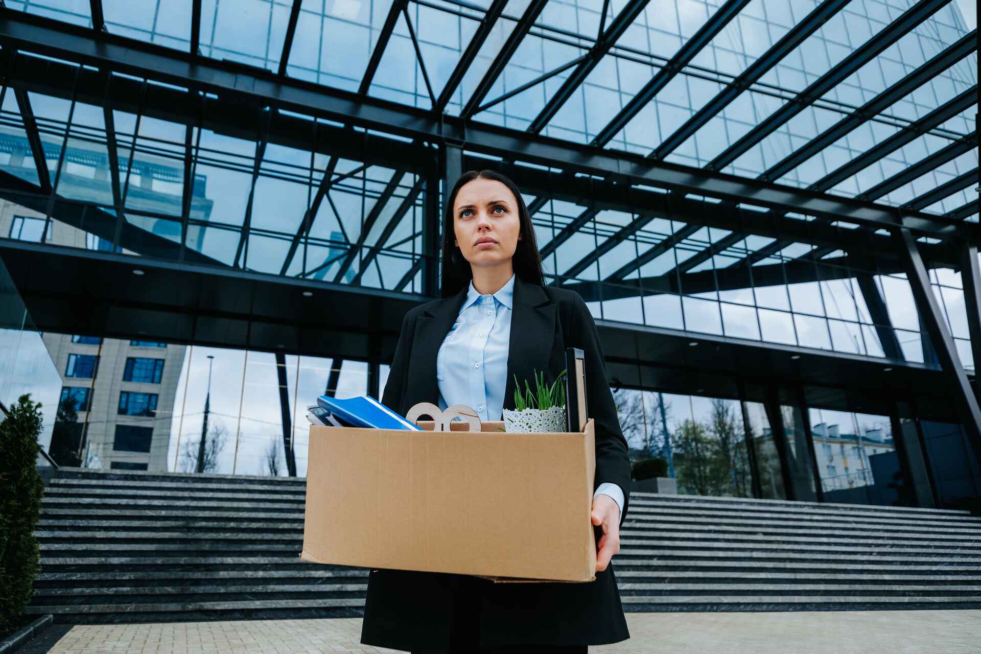 woman holding box in front of company