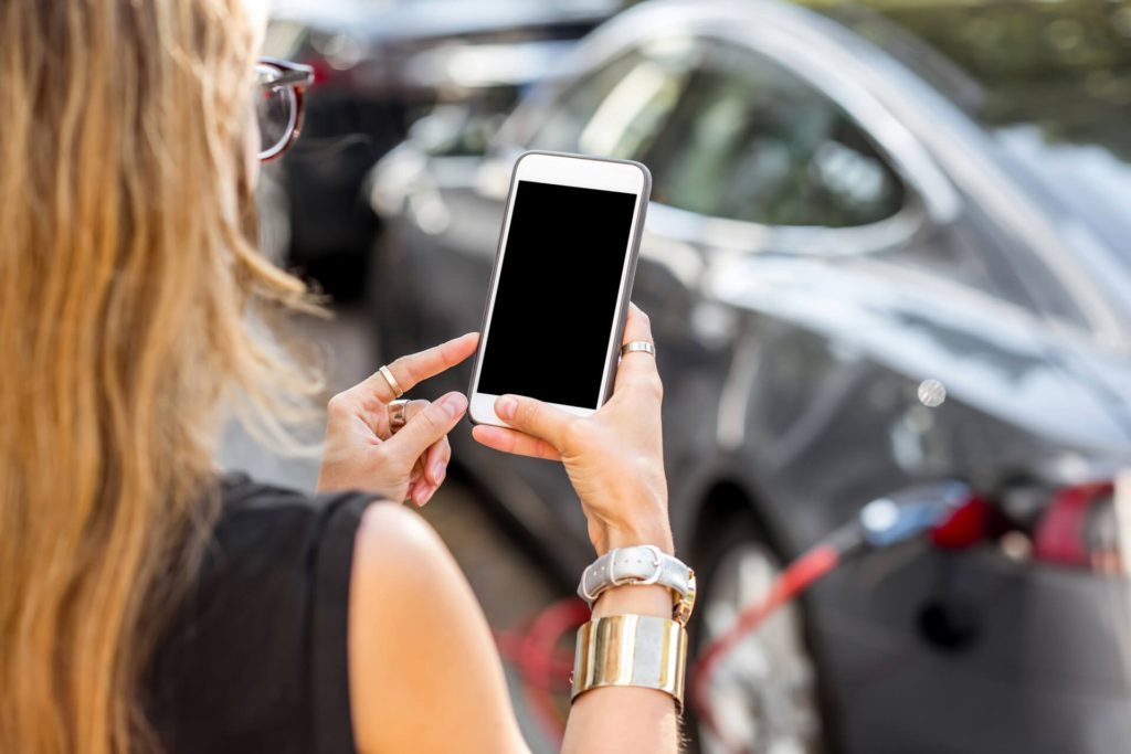 woman holding her phone after an accident in a rideshare car